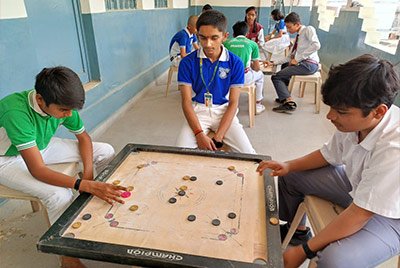 Students playing carrom