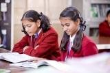 Two students reading together in the classroom