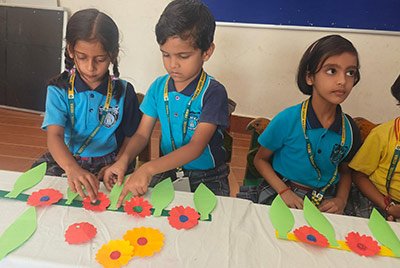 Students working on a flower craft activity