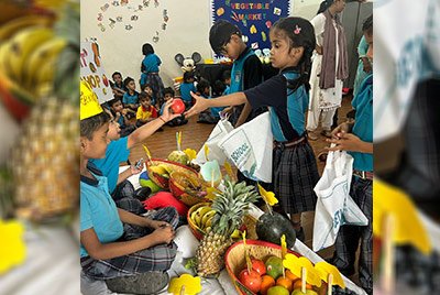 Young students role-playing a fruit and vegetable market